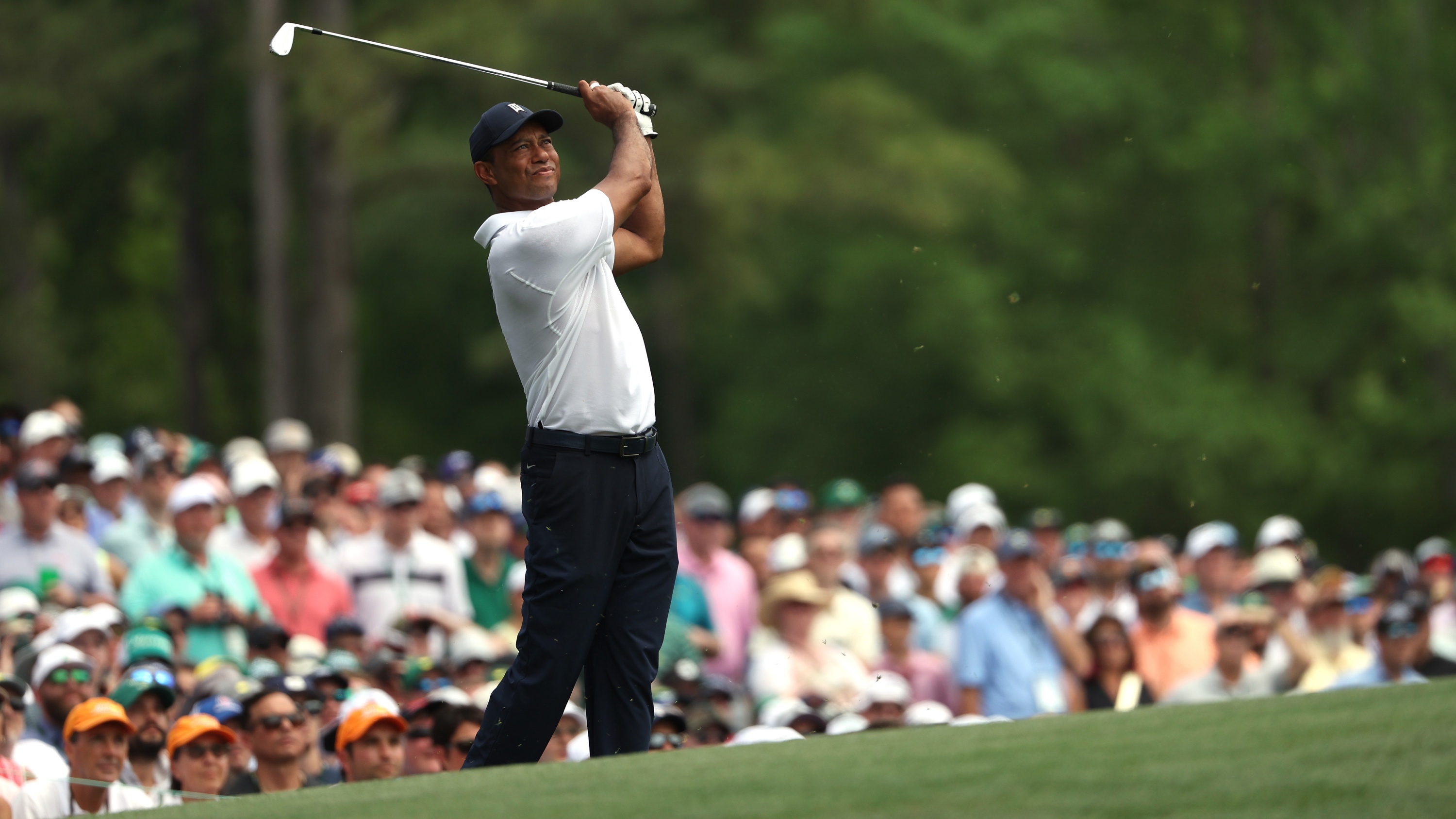 Tiger Woods at The Masters hitting from a bunker at Augusta National