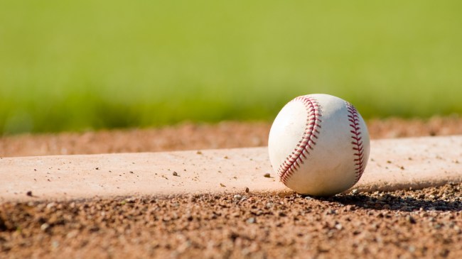 A baseball sits beside the pitching rubber.