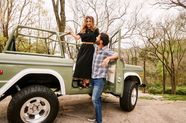 Eric Decker and his wife, Jesse James Decker pictured outside in an old Ford Bronco