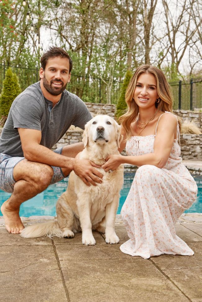 Eric Decker and his wife, Jesse James Decker pictured outside by the pool with a dog