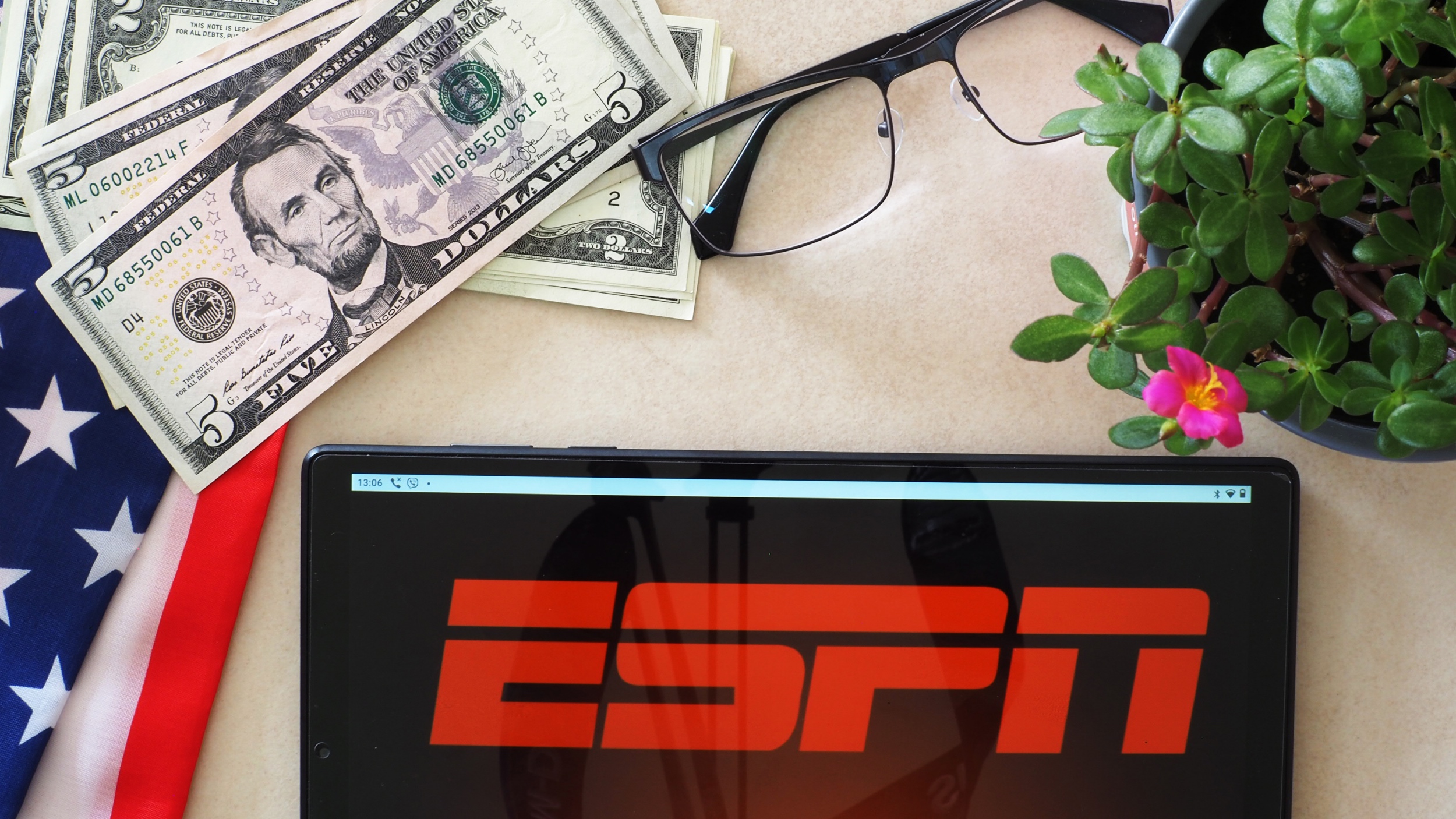 ESPN logo next to pile of cash