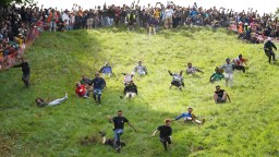 Woman Wins Gloucester Cheese-Rolling Race Despite Getting Knocked Out While Competing
