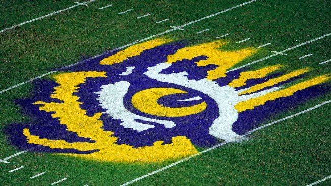 An LSU Tigers logo on the football field.