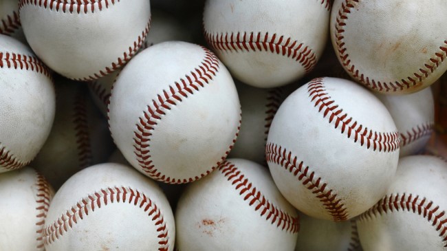 A group of baseballs in a basket.