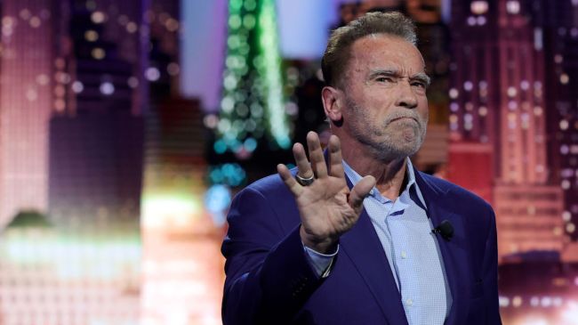 Actor Arnold Schwarzenegger holding up his hand