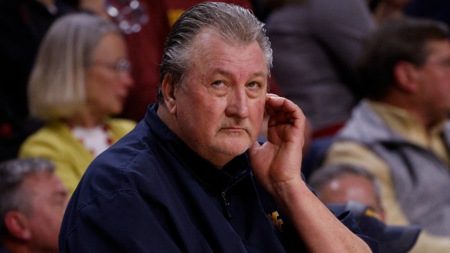 Bob Huggins sits on the bench at a West Virginia basketball game.