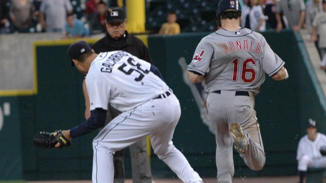 Armando Galarraga tags first base as a baserunner comes down the line.