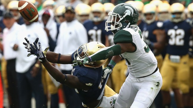 A Michigan State defender breaks up a pass attempt to a Notre Dame receiver.