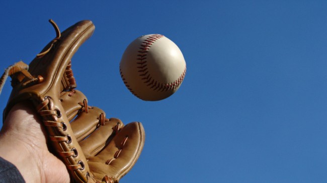 A fielder tries to catch a baseball.