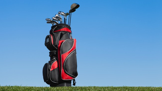 A golf bag sits on the course.