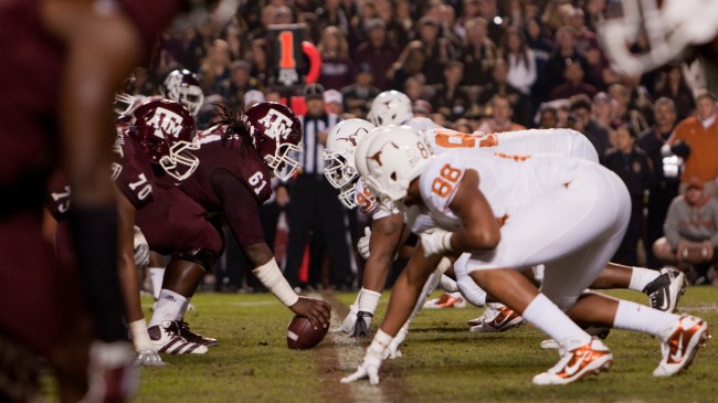 Texas and Texas A&M players at the line of scrimmage during a football game.