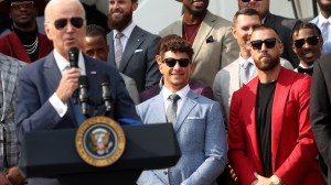 Travis Kelce and Patrick Mahomes stand at the White House while President Joe Biden speaks,