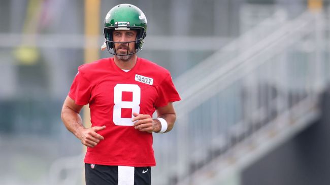 aaron rodgers in a red jersey at new york jets practice