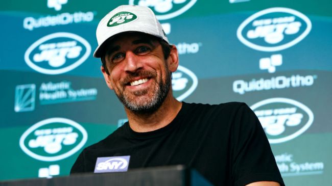 aaron rodgers smiling at a jets press conference