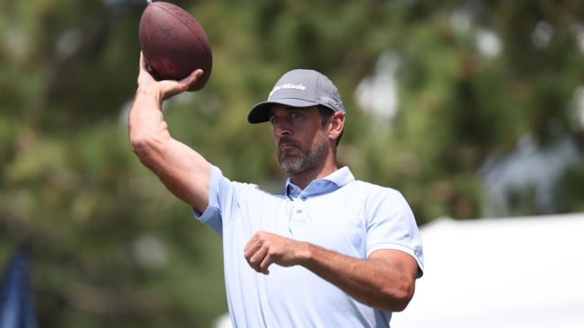 aaron rodgers throwing a football at a golf tournament