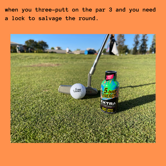 Putting green with a putter and a golf ball and a 5-hour ENERGY bottle
