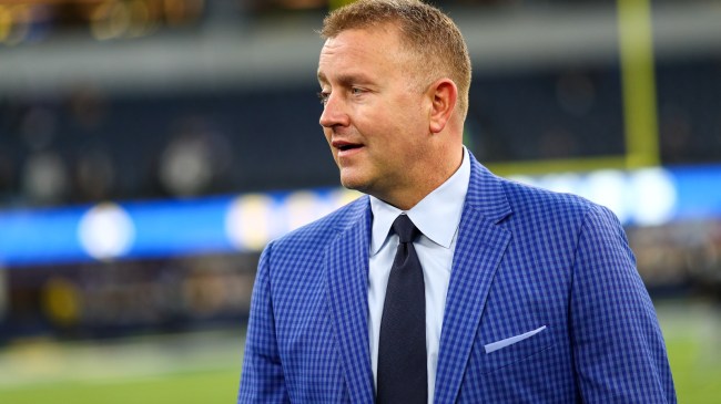 Kirk Herbstreit on the field at an NFL game.