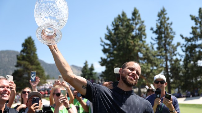 Steph Curry hoists the trophy after winning the American Century Championship.