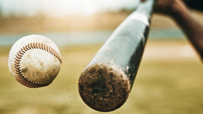 A bat makes contact with a baseball.