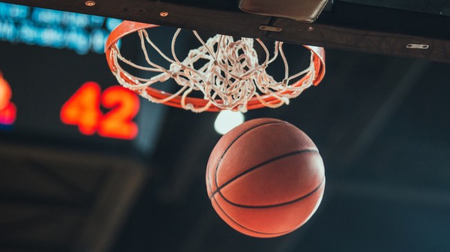 A basketball swishes through the net.