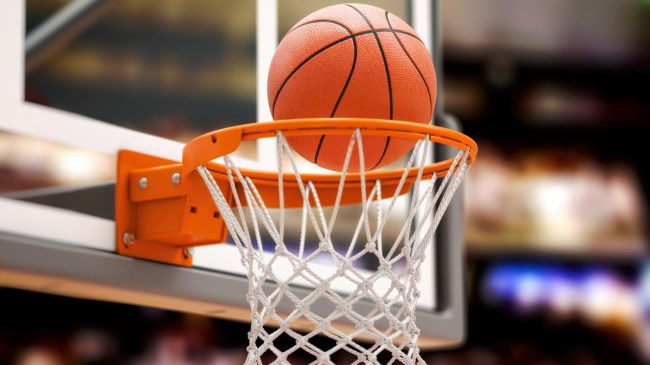 A basketball swishes through a hoop.