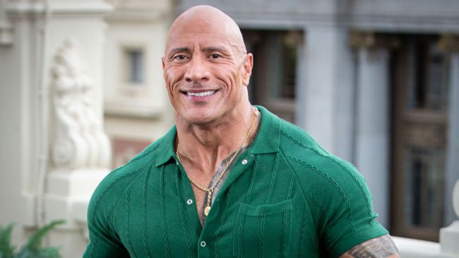 the rock in a green shirt