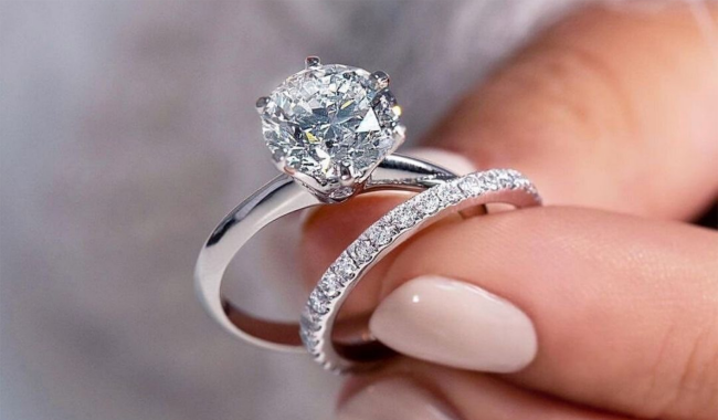 woman holding engagement wedding rings