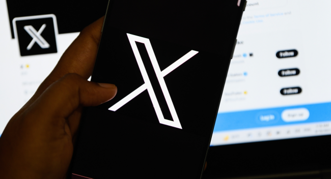 X logo twitter on phone computer