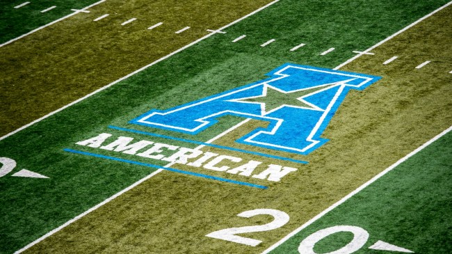 An American Athletic Conference logo on the football field.