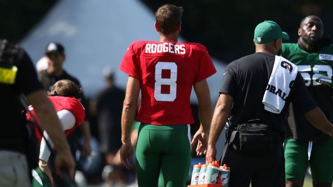 aaron rodgers in a red jersey at jets practice