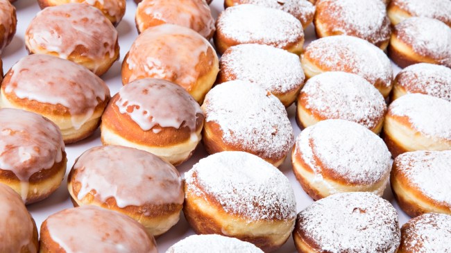 Glazed and powdered doughnuts ready to be served.