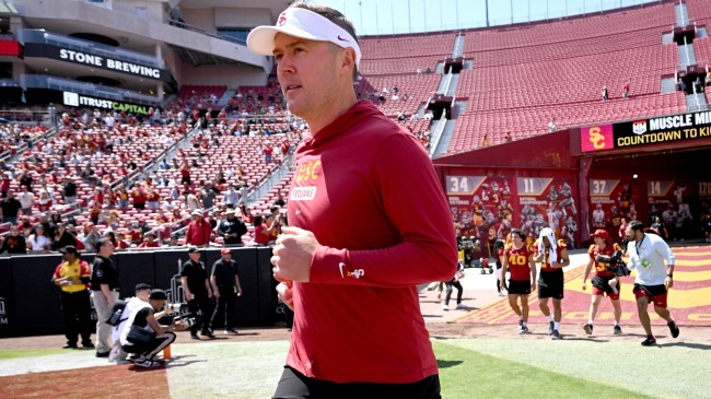 Lincoln Riley runs onto the field at the USC spring game.