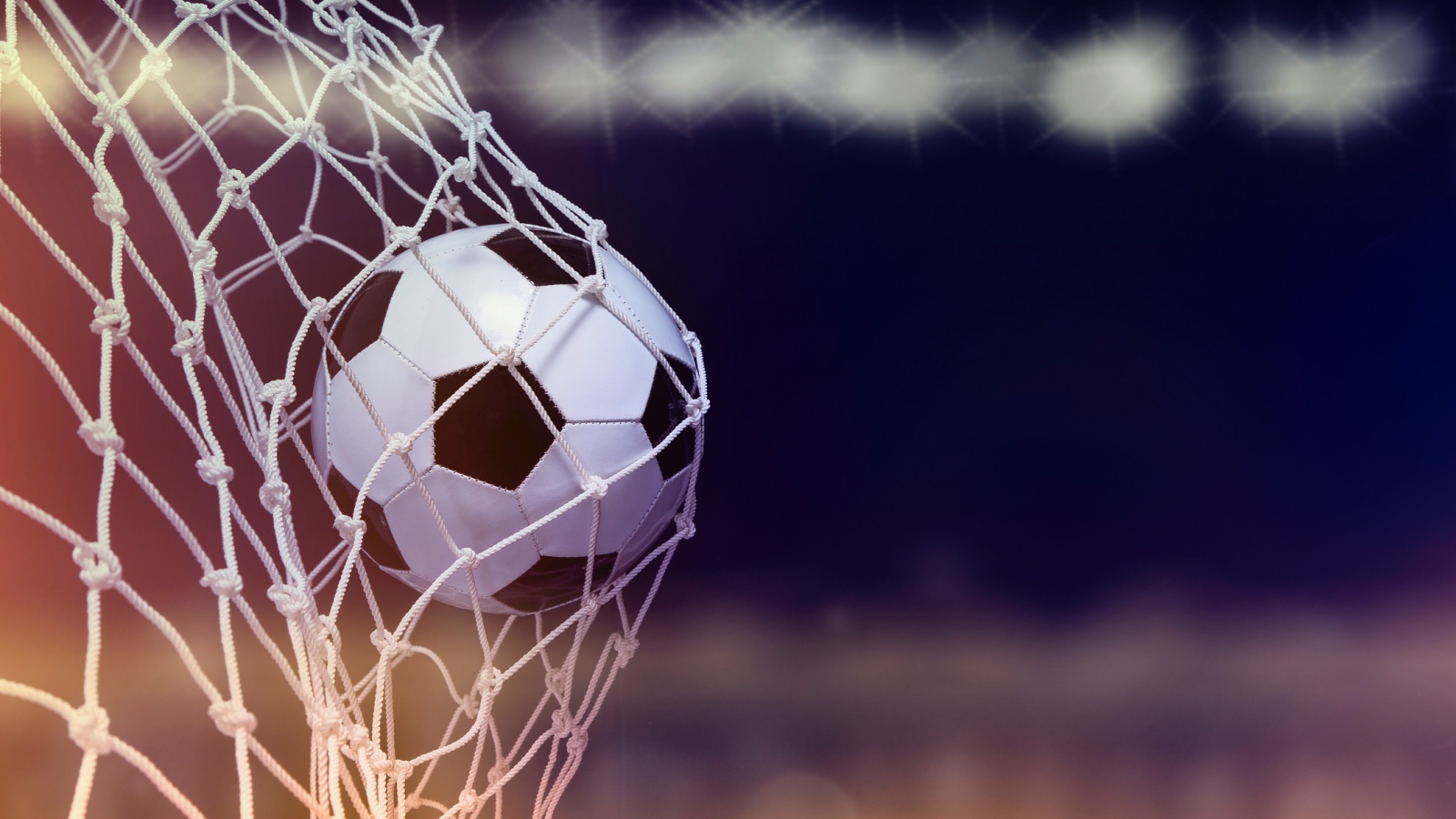 soccer ball going into a net