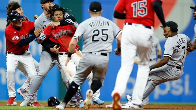 Jose Ramirez is pulled away after punching Tim Anderson.
