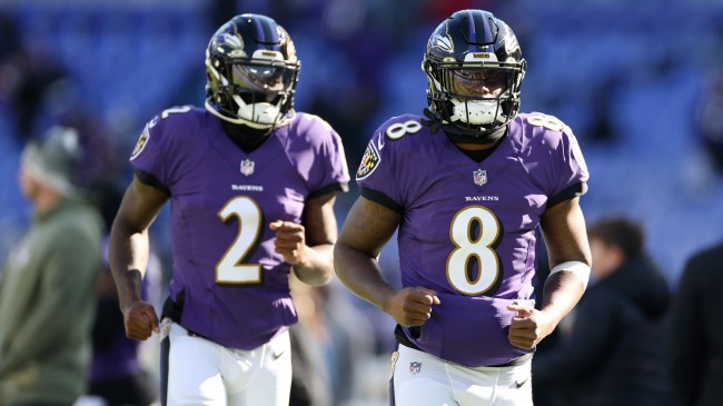 Lamar Jackson and Tyler Huntley walk onto the field for the Baltimore Ravens.