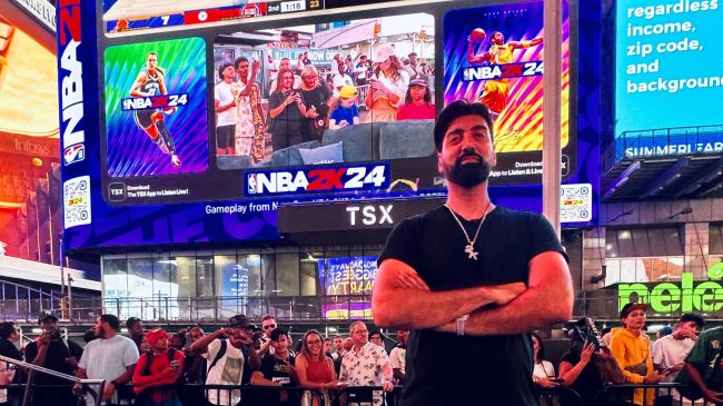 Ronnie 2K in front of a NBA 2K24 billboard in Times Square