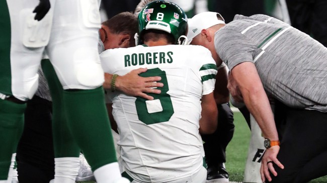 Aaron Rodgers tended to by medical staff after suffering an injury.