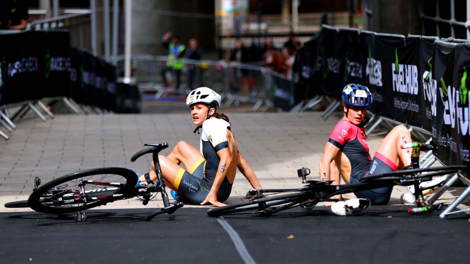 Triathlon athlete Alice Betto crashes bike after teammate Nicole van der Kaay pushes her into barrier.