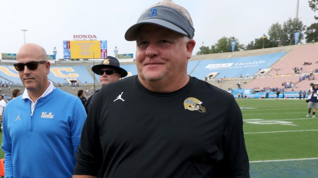 Chip Kelly walks off the field after a UCLA football game.