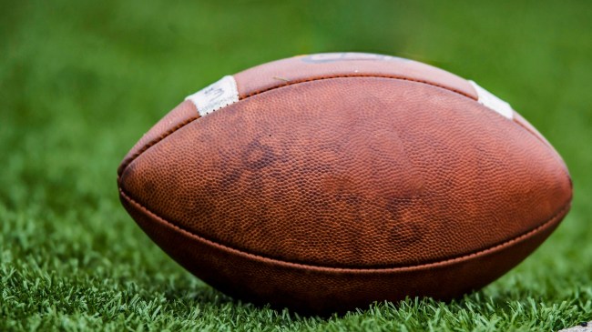 A football rests on the playing field.