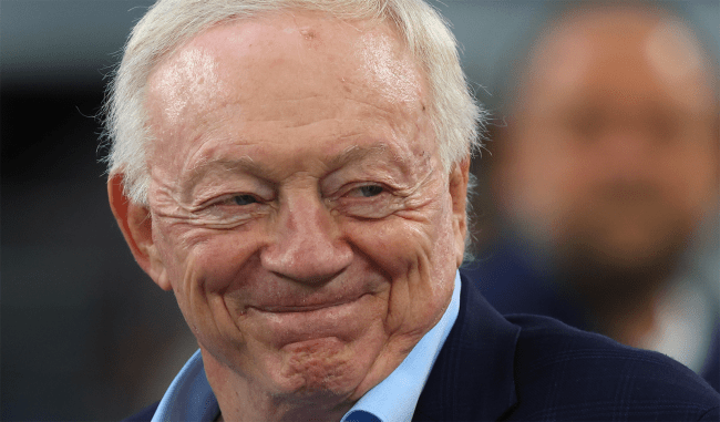 jerry jones smiles on the field at cowboys game