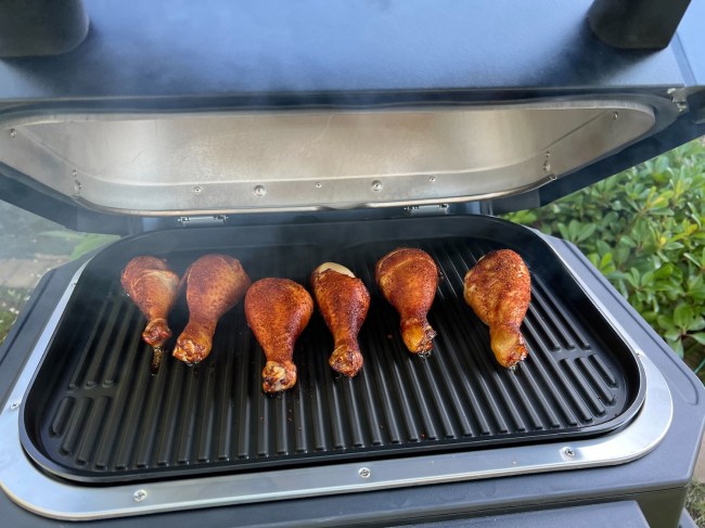 Chicken drumsticks on the grill of the Ninja Woodfire™ Pro Connect XL Outdoor Grill & Smoker