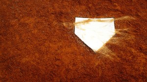 A view of home plate on a baseball diamond.