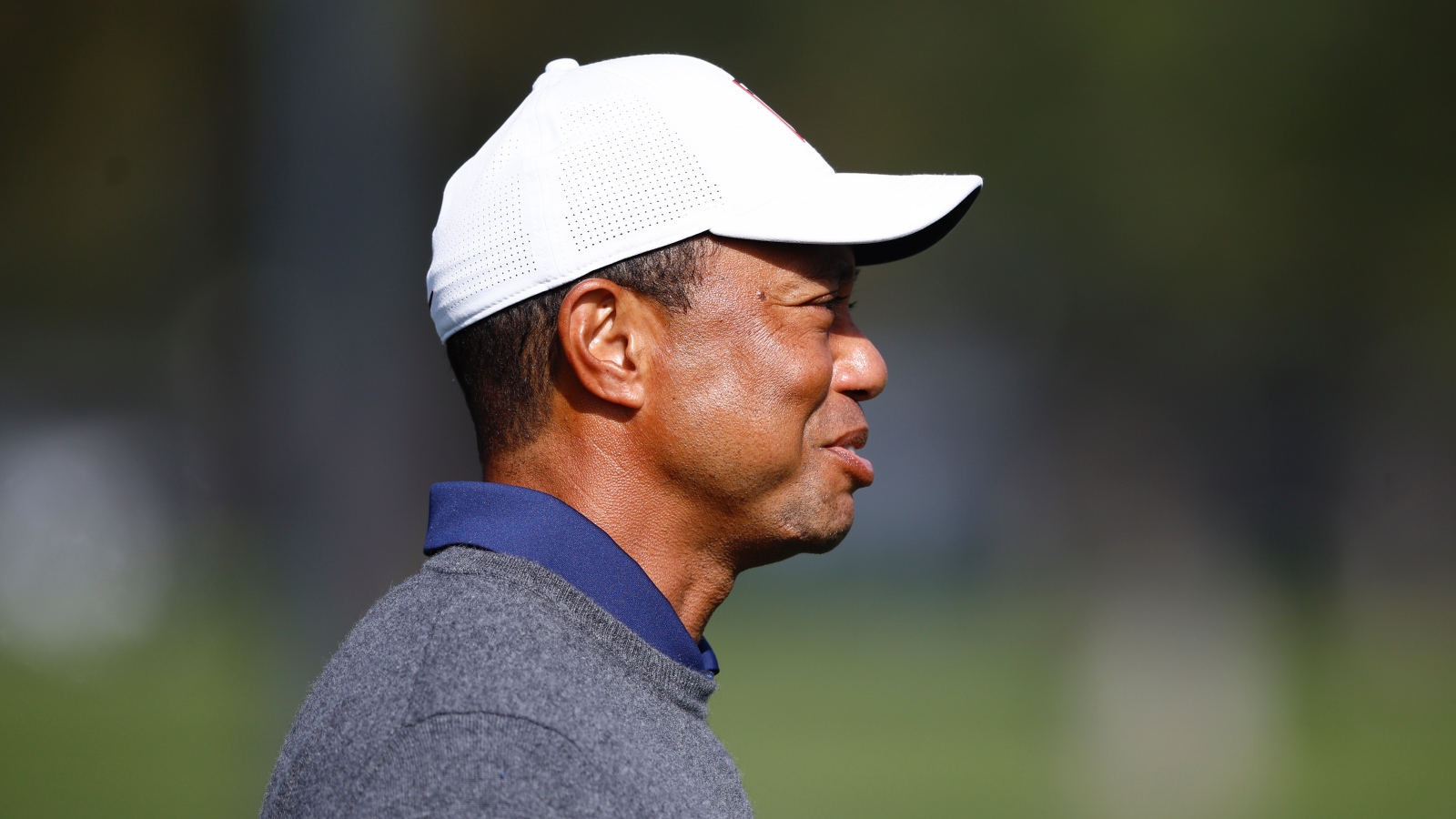 Tiger Woods smiling on the golf range