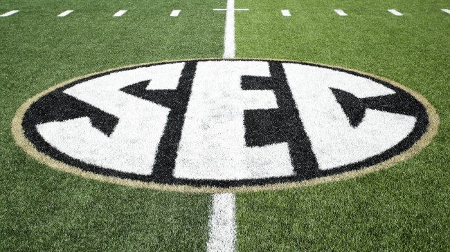 An SEC logo in black and gold on the playing field before a Vanderbilt game.