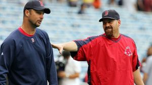 Kevin Youkillis of the Boston Red Sox jokes with teammate Tim Wakefield