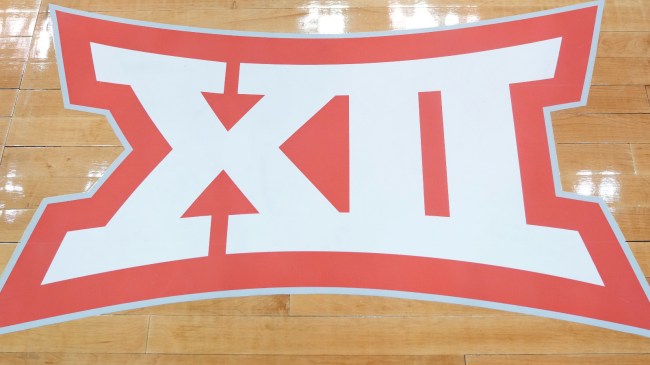 A Big XII logo on a basketball court.