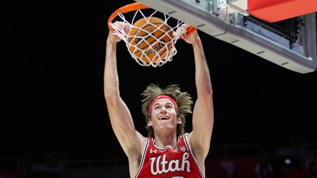 Branden Carlson slam dunks during a Utah basketball game.