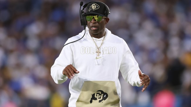 Deion Sanders walks the sidelines during a game between Colorado and UCLA.