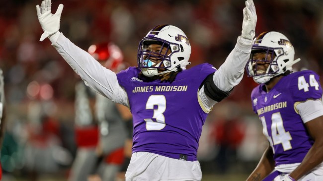 A James Madison football player celebrates a play on the field.